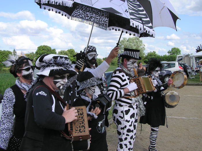 <p>The band, with umbrellas repurposed as parasols</p>