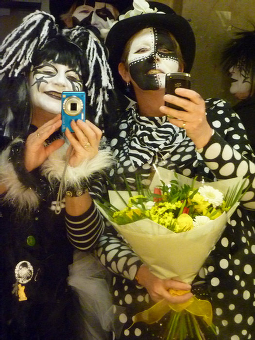 <p>Taking simultaneous pics of each other in the mirror, or something....?</p>
